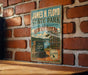A vintage-style metal sign for James H. Floyd State Park in Georgia, featuring a scenic illustration of the park and its surroundings.
