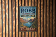 A vintage-style sign for James M. Robb Colorado River State Park, featuring a scenic mountain landscape.