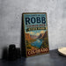 A vintage-style metal sign for James M. Robb Colorado River State Park, featuring a scenic mountain landscape.