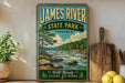 A vintage-style sign for James River State Park in Virginia, featuring a scenic landscape with a river, trees, and mountains.