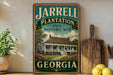 A vintage-style sign for the state historic site of Jarrell Plantation in Georgia, featuring a house surrounded by trees and flowers.