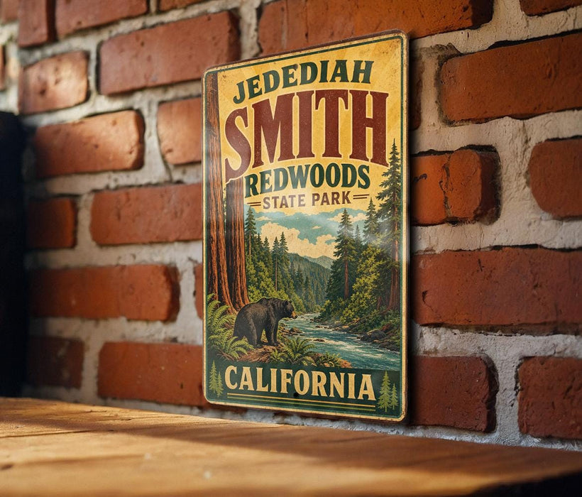 A vintage metal sign for JEDEDIAH SMITH REDWOODS STATE PARK in California, featuring a scenic illustration of a bear in the foreground with a river and forest in the background.
