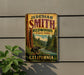A vintage-style metal sign for Jedediaah Smith Redwoods State Park in California, featuring a scenic illustration of a bear in the foreground and a forest landscape in the background.