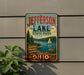 A vintage-style metal sign for Jefferson Lake State Park, featuring a scenic image of a lake, a sailboat, and a forest.
