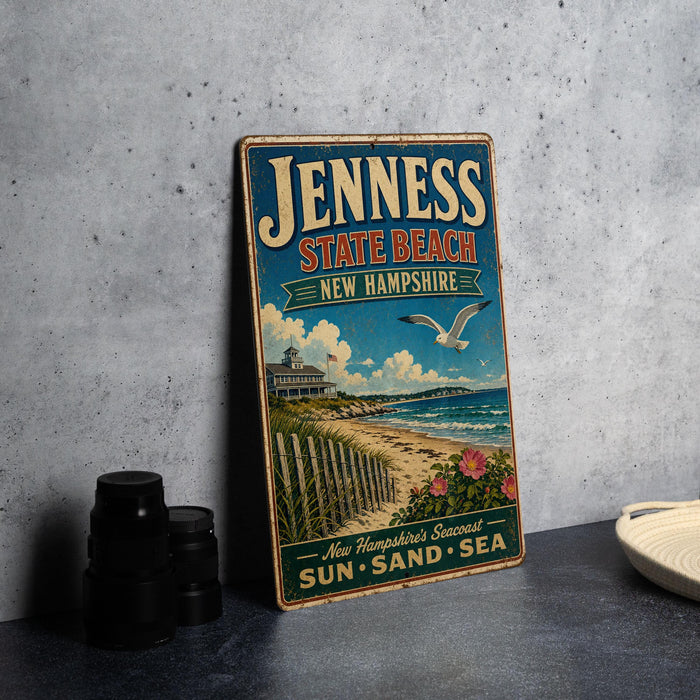 A vintage-style metal sign advertising the beach town of Jenness, New Hampshire, with a beach scene and a seagull in flight.
