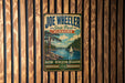 A vintage-style metal sign for Joe Wheeler State Park in Alabama, featuring a scenic illustration of a lake and a sailboat.