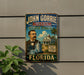 A vintage-style metal sign for the John Gorrie Museum in Florida, featuring an illustration of a man in a suit and tie, with a house and palm trees in the background.