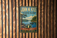A vintage-style metal sign for John W. Kyle State Park, featuring a scenic image of a lake and forest.