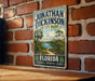 A vintage-style sign for Jonathan Dickinson State Park, featuring a scenic illustration of a tropical landscape with palm trees and a body of water.