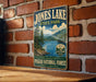A vintage-style metal sign for Jones Lake State Park, featuring a scenic landscape with pine trees, mountains, and a lake.