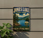 A vintage-style sign for Jones Lake State Park, featuring a scenic landscape with pine trees, mountains, and a lake.