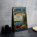A vintage-style metal sign for Jordan Lake, North Carolina, featuring a scenic illustration of a lake, canoe, and trees.