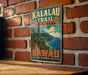 A vintage metal sign for Kalalau Trail State Park in Hawaii, featuring a scenic mountain landscape and the text "Hawaii The Garden Isle".