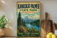 A vintage-style sign for Kanaskat-Palmer State Park in Washington, featuring a scenic mountain landscape with a river and pine trees.