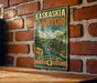 A vintage-style metal sign for Kaskaskia Canyon State Park in Illinois, featuring a scenic illustration of the canyon landscape.