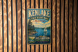 A vintage-style metal sign for Kenlake State Resort Park in Kentucky, featuring a scenic image of a lake with a sailboat and pine trees.