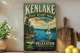 A vintage-style sign for Kenlake State Resort Park in Kentucky, featuring a scenic image of a lake with a sailboat, surrounded by pine trees and mountains.