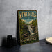 A vintage-style sign for Kent Falls State Park in Connecticut, featuring a scenic illustration of a waterfall surrounded by lush greenery.