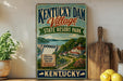 A vintage-style sign for Kentucky Dam Village State Resort Park, featuring a scenic illustration of the park and its surroundings.