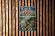 A vintage-style sign for Kentucky Dam Village State Resort Park, featuring a scenic illustration of the park and its surroundings.
