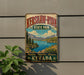 A vintage-style metal sign for Kershaw-Ryan State Park in Nevada, featuring a scenic landscape with mountains, a lake, and pine trees.