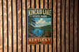 A vintage metal sign for Kincaid Lake State Park in Kentucky, featuring a scenic image of the lake and surrounding landscape.