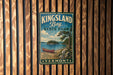 A vintage-style metal sign for Kingsland Bay State Park, featuring a scenic illustration of a lake, a canoe, and a forested shoreline.