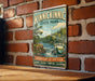 A vintage-style metal sign for Kinnickinnic State Park, featuring a scenic landscape with a waterfall and trees, mounted on a brick wall.