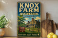 A vintage-style sign for Knox Farm State Park in New York, featuring a house and trees in the background.