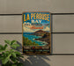 A vintage-style metal sign for La Perouse Bay State Historical Park in Hawaii, featuring a scenic image of the bay and mountains.