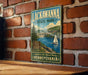 A vintage-style metal sign for Lackawanna State Park in Pennsylvania, featuring a scenic illustration of a lake, bridge, and sailboat.