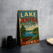 A vintage-style sign for Lake Anita State Park in Iowa, featuring a scenic illustration of a lake, canoe, and surrounding landscape.