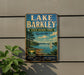 A vintage-style sign for Lake Barkley State Resort Park in Kentucky, featuring a scenic image of the lake and surrounding landscape.
