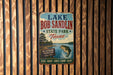 A vintage metal sign for Lake Bob Sandlin State Park in Texas, featuring a fishing scene and the text "An Outdoor Tradition Since 1977" and "FISH - BOAT - HIK - CAMP - Relax".