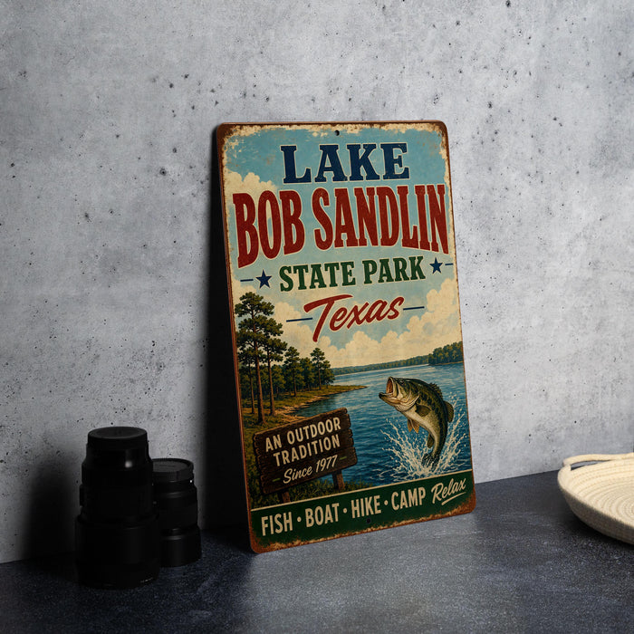A vintage-style sign advertising Lake Bob Sandlin State Park in Texas, featuring a lake, trees, and a fish jumping out of the water.