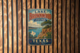 A vintage-style metal sign for Lake Brownwood State Park in Texas, featuring a scenic landscape with a lake, mountains, and a tree.