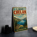 A vintage-style sign for Lake Chelan State Park in Washington, featuring a scenic landscape with mountains, trees, and a lake.