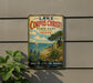 A vintage metal sign advertising Lake Corps Christi State Park in Texas, featuring a scenic illustration of a lake, palm trees, and a sailboat.