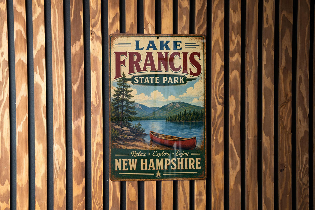 A vintage metal sign for Lake Francis State Park in New Hampshire, featuring a scenic image of a lake with a canoe and mountains in the background.