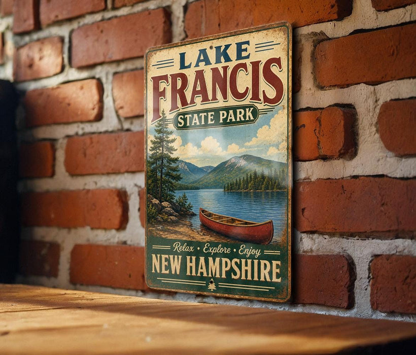 A vintage-style metal sign for Lake Francis State Park in New Hampshire, featuring a scenic image of a lake with a canoe and mountains in the background.