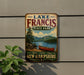 A vintage-style metal sign for Lake Francis State Park in New Hampshire, featuring a scenic image of a lake with a canoe and mountains in the background.