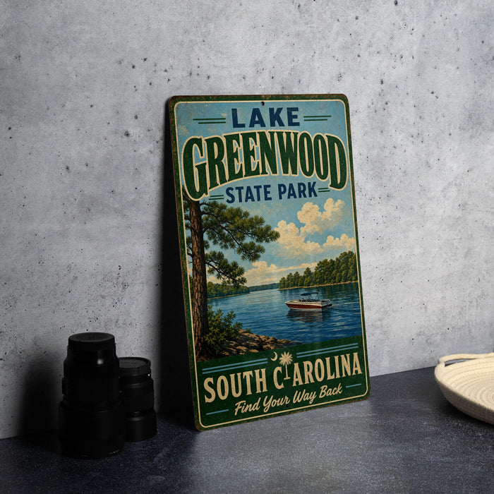 A vintage-style sign for Lake Greenwood State Park in South Carolina, featuring a scenic image of a lake with a boat and trees.