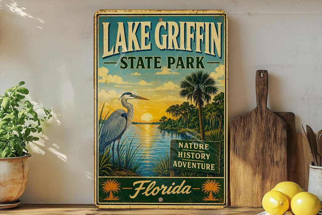 A vintage-style sign for Lake Griffin State Park in Florida, featuring a seagull, palm trees, and a sunset over the water.