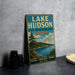 A vintage-style metal sign for Lake Hudson State Recreation Area in Michigan, featuring a scenic landscape with a lake, mountains, and pine trees.