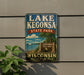 A vintage-style sign for Lake Kegona State Park in Wisconsin, featuring a scenic illustration of the park and its surroundings.