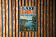 A vintage-style sign for Lake Le-Aqua-NA, a state recreation area in Illinois, featuring a scenic image of a lake and boats.