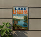 A vintage-style metal sign for Lake Le-Aqua-NA, a state recreation area in Illinois, featuring a scenic image of a lake with people fishing and hiking.