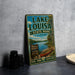 A vintage-style metal sign for Lake Louisa State Park in Florida, featuring a scenic illustration of a lake, canoe, and surrounding nature.