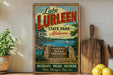 A vintage-style sign for Lake Lurleen State Park in Alabama, featuring a scenic image of the lake and surrounding landscape.