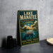 A vintage-style metal sign for Lake Manatee State Park in Florida, featuring an illustration of a manatee swimming in a lake surrounded by palm trees and a sunset sky.